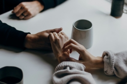 Image 1 hands holding on a table top