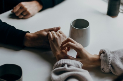 Image 1 hands holding on a table top